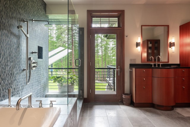 6601 Russian Joe Rd, Missoula, MT 59802 - full bath featuring a tile shower, vanity, a bath, and healthy amount of natural light