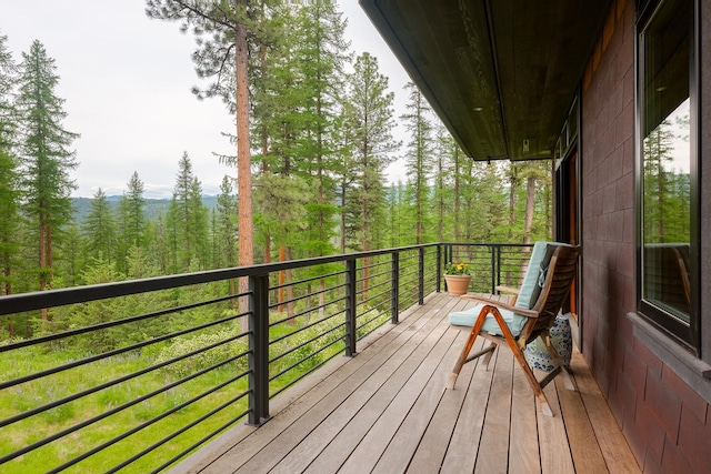 6601 Russian Joe Rd, Missoula, MT 59802 - wooden terrace featuring a wooded view