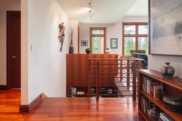 6601 Russian Joe Rd, Missoula, MT 59802 - hall with wood finished floors, rail lighting, and an upstairs landing
