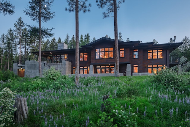 6601 Russian Joe Rd, Missoula, MT 59802 - back of property with stairway, a chimney, a balcony, and a garage