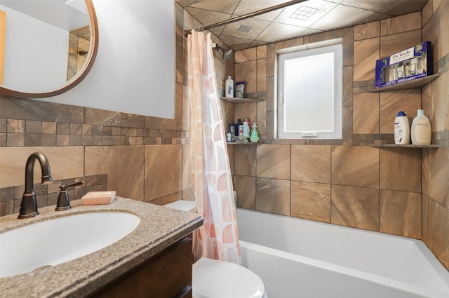 704 43rd St N, Great Falls, MT 59405 - bathroom featuring shower / bathtub combination with curtain, vanity, tile walls, and decorative backsplash