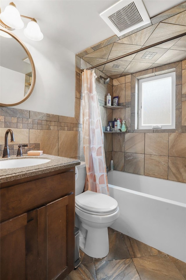 704 43rd St N, Great Falls, MT 59405 - bathroom featuring tile walls, vanity, and shower / tub combo with curtain
