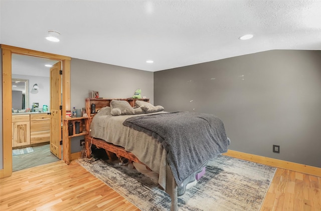 704 43rd St N, Great Falls, MT 59405 - bedroom with light wood-type flooring, ensuite bath, and recessed lighting