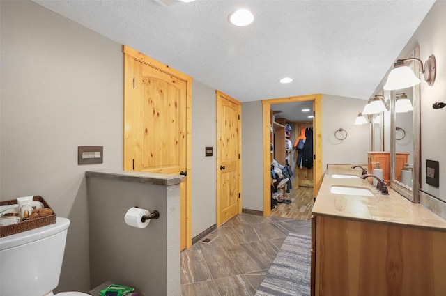 704 43rd St N, Great Falls, MT 59405 - bathroom featuring double vanity, recessed lighting, and a textured ceiling