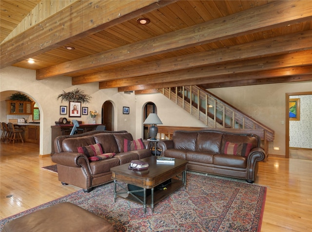 14371 Hidden Bay Ln, Bigfork, MT 59911 - living room featuring arched walkways, a wooden ceiling with exposed beams, wood finished floors, stairway, and recessed lighting