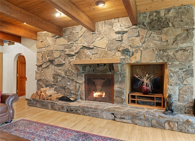 14371 Hidden Bay Ln, Bigfork, MT 59911 - detailed view of a wood ceiling with exposed beams, arched walkways, wood finished floors, and a fireplace