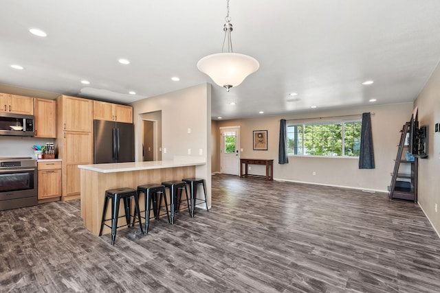 2150 Teal Dr, Kalispell, MT 59901 - kitchen with appliances with stainless steel finishes, light brown cabinetry, dark wood finished floors, light countertops, and recessed lighting
