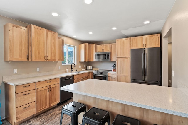 2150 Teal Dr, Kalispell, MT 59901 - kitchen with stainless steel appliances, light brown cabinetry, a kitchen bar, a peninsula, and recessed lighting