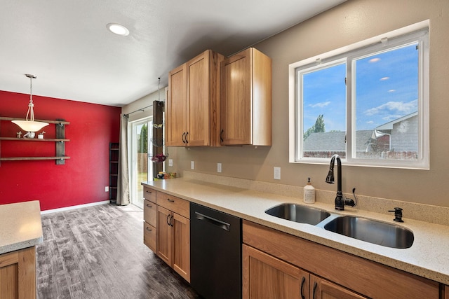 2150 Teal Dr, Kalispell, MT 59901 - kitchen with dishwashing machine, dark wood-style flooring, pendant lighting, and brown cabinetry