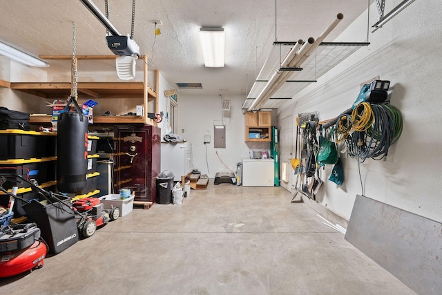 2150 Teal Dr, Kalispell, MT 59901 - garage featuring electric panel, washer / dryer, and a garage door opener