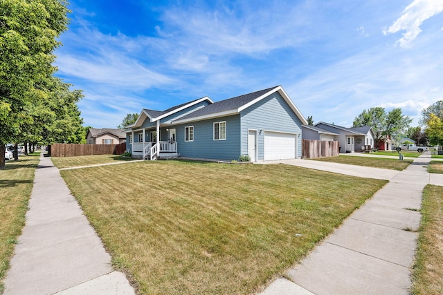 2150 Teal Dr, Kalispell, MT 59901 - view of front of house featuring covered porch, concrete driveway, an attached garage, and roof with shingles