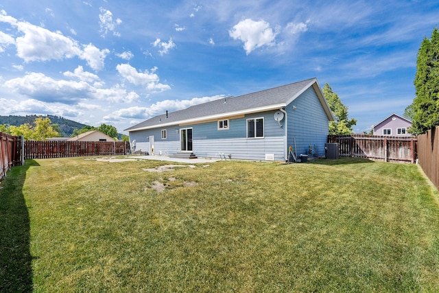 2150 Teal Dr, Kalispell, MT 59901 - back of house with a fenced backyard and entry steps