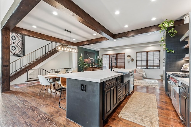 153 Slopeside Dr Unit 14, Whitefish, MT 59937 - kitchen with open floor plan, light countertops, beamed ceiling, dark wood-style flooring, and a breakfast bar area