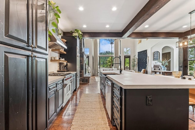 153 Slopeside Dr Unit 14, Whitefish, MT 59937 - kitchen featuring plenty of natural light, light countertops, beam ceiling, recessed lighting, and a large island with sink
