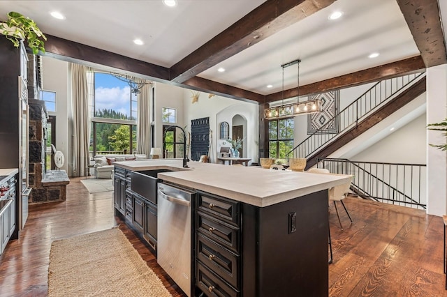 153 Slopeside Dr Unit 14, Whitefish, MT 59937 - kitchen with dishwasher, open floor plan, beam ceiling, light countertops, and a chandelier