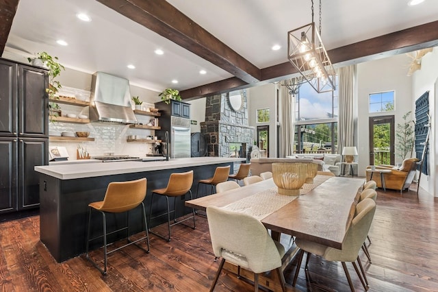 153 Slopeside Dr Unit 14, Whitefish, MT 59937 - dining space with beamed ceiling, recessed lighting, dark wood finished floors, a chandelier, and a fireplace