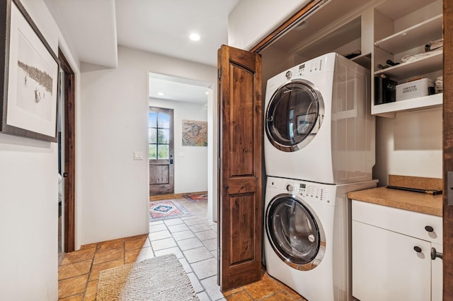 153 Slopeside Dr Unit 14, Whitefish, MT 59937 - laundry room featuring stacked washer / drying machine, recessed lighting, and stone tile floors