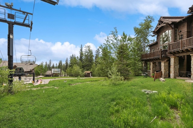 153 Slopeside Dr Unit 14, Whitefish, MT 59937 - view of green lawn featuring a deck