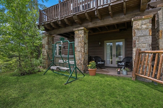 153 Slopeside Dr Unit 14, Whitefish, MT 59937 - exterior space with french doors, a yard, stone siding, and a deck