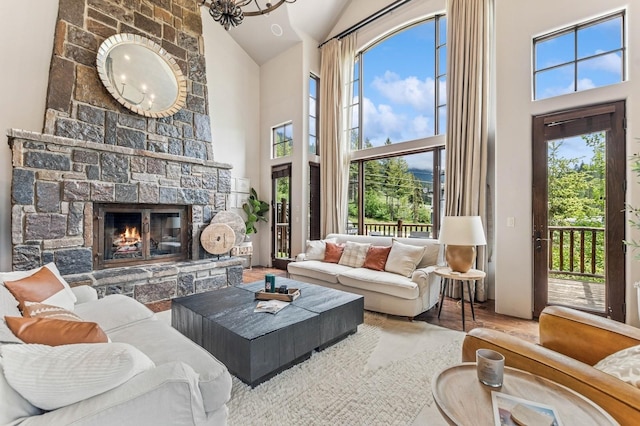 153 Slopeside Dr Unit 14, Whitefish, MT 59937 - living area with high vaulted ceiling, a stone fireplace, wood finished floors, and healthy amount of natural light