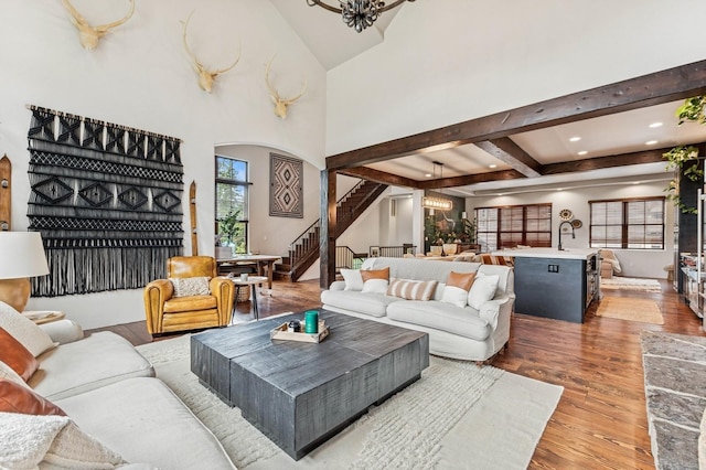153 Slopeside Dr Unit 14, Whitefish, MT 59937 - living room with wood finished floors, stairs, a chandelier, beamed ceiling, and recessed lighting