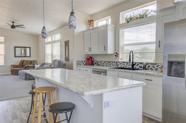 5610 Hauser Damn Rd, Helena, MT 59602 - kitchen with stainless steel appliances, a kitchen island, open floor plan, a kitchen breakfast bar, and ceiling fan