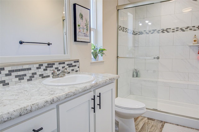 5610 Hauser Damn Rd, Helena, MT 59602 - full bath with vanity, a shower stall, tasteful backsplash, and wood finished floors