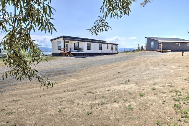 5610 Hauser Damn Rd, Helena, MT 59602 - view of front facade featuring a deck and dirt driveway