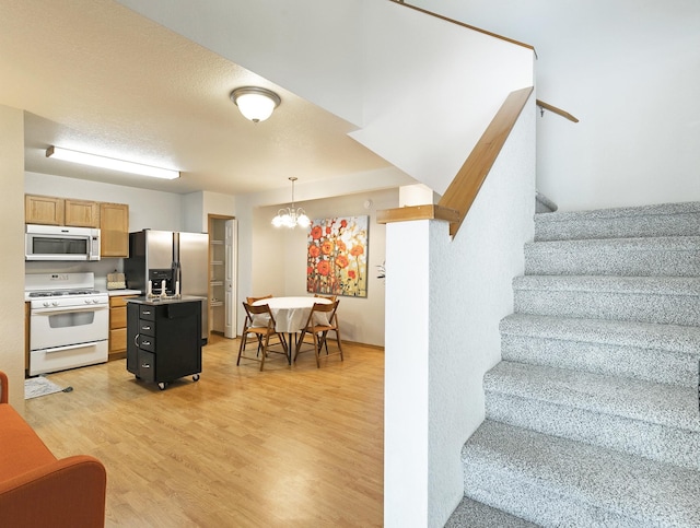 4431 Chesapeake Way, Missoula, MT 59808 - stairway featuring wood finished floors and a chandelier