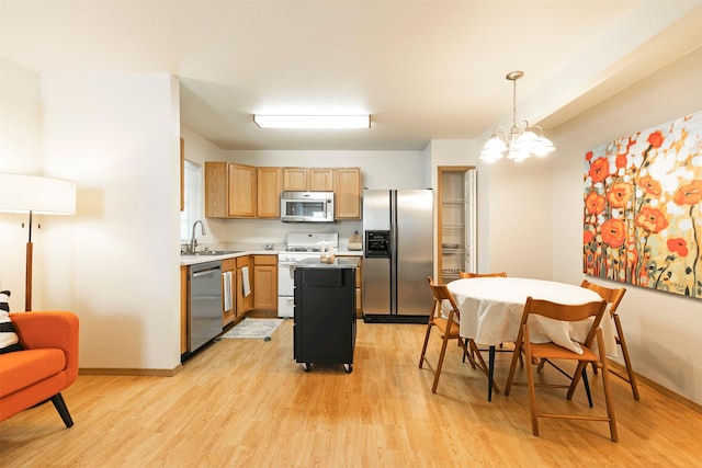 4431 Chesapeake Way, Missoula, MT 59808 - kitchen with stainless steel appliances, light wood-type flooring, and a chandelier