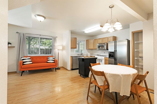 4431 Chesapeake Way, Missoula, MT 59808 - kitchen featuring stainless steel appliances, a kitchen island, a chandelier, light wood-style flooring, and light countertops