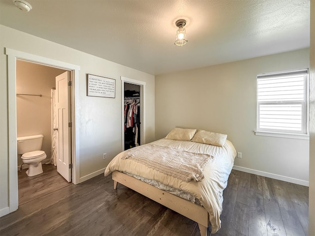 2876 Twilight Ave, Helena, MT 59601 - bedroom with dark wood-style floors, ensuite bathroom, a closet, and a walk in closet