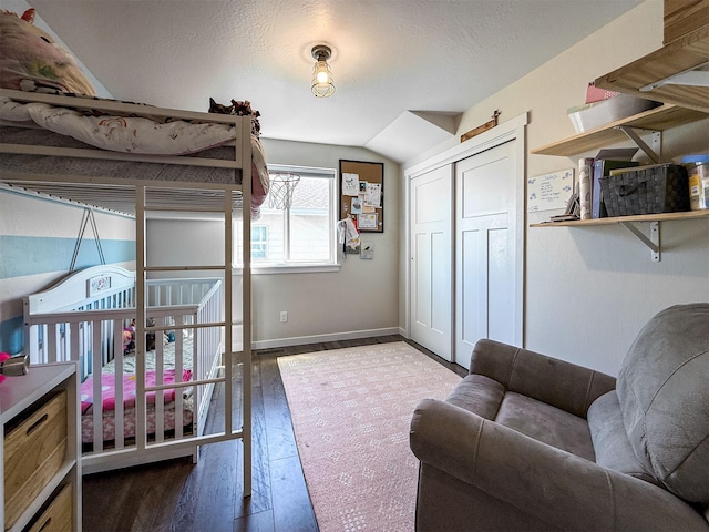 2876 Twilight Ave, Helena, MT 59601 - bedroom with wood finished floors, lofted ceiling, a closet, and a textured ceiling
