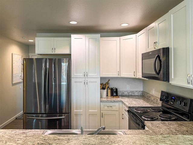 2876 Twilight Ave, Helena, MT 59601 - kitchen featuring black appliances, white cabinetry, recessed lighting, wood finished floors, and light stone counters