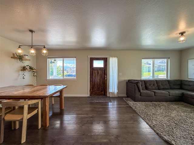 2876 Twilight Ave, Helena, MT 59601 - dining room with healthy amount of natural light, dark wood-type flooring, and a textured ceiling