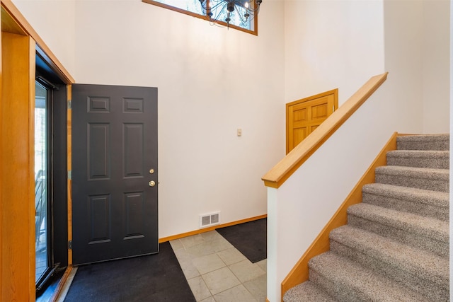 183B Eagle Bend Dr, Bigfork, MT 59911 - tiled foyer featuring a towering ceiling, a chandelier, and stairs