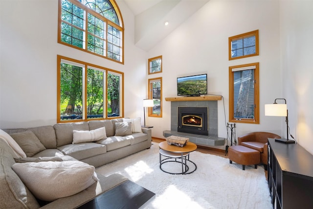 183B Eagle Bend Dr, Bigfork, MT 59911 - living room featuring high vaulted ceiling, a tile fireplace, wood finished floors, and recessed lighting