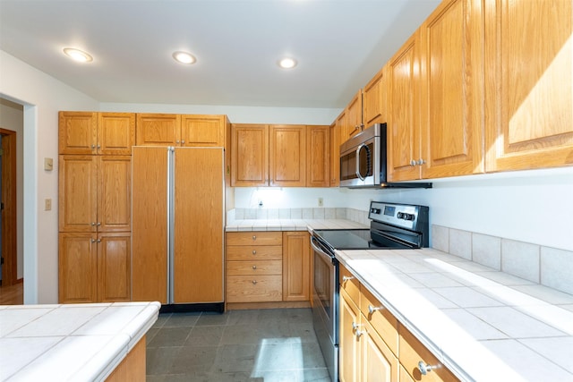 183B Eagle Bend Dr, Bigfork, MT 59911 - kitchen with appliances with stainless steel finishes, tile counters, and recessed lighting