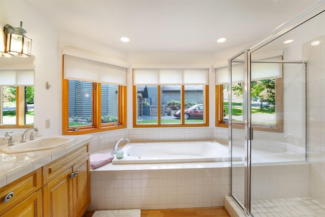 183B Eagle Bend Dr, Bigfork, MT 59911 - bathroom with vanity, a bath, a shower stall, and recessed lighting