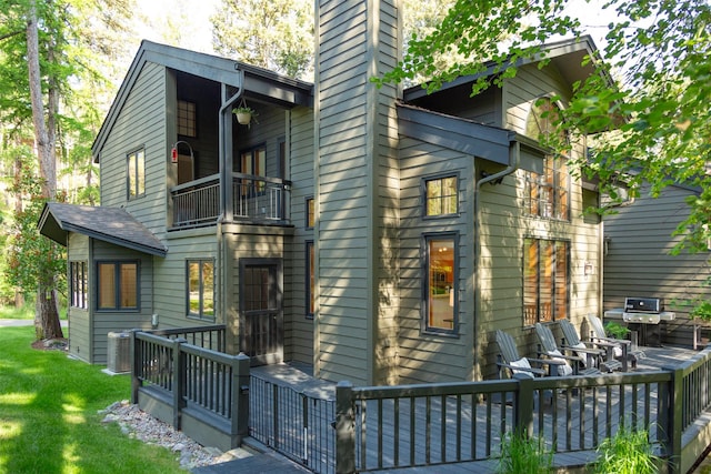 183B Eagle Bend Dr, Bigfork, MT 59911 - view of front of property with a balcony, a chimney, and a front lawn
