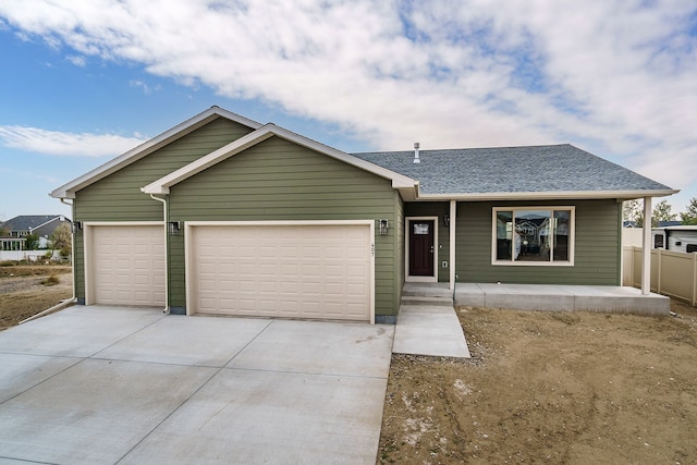 243 Stirling Loop, East Helena, MT 59635 - ranch-style house featuring driveway, an attached garage, a shingled roof, and a porch