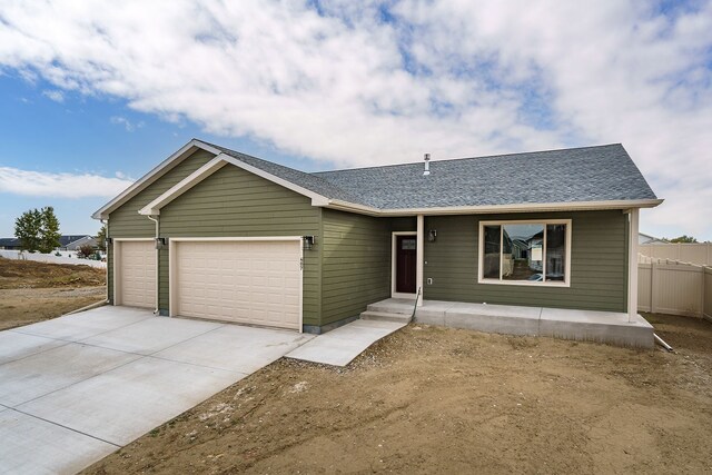 243 Stirling Loop, East Helena, MT 59635 - ranch-style home with an attached garage, driveway, and a shingled roof