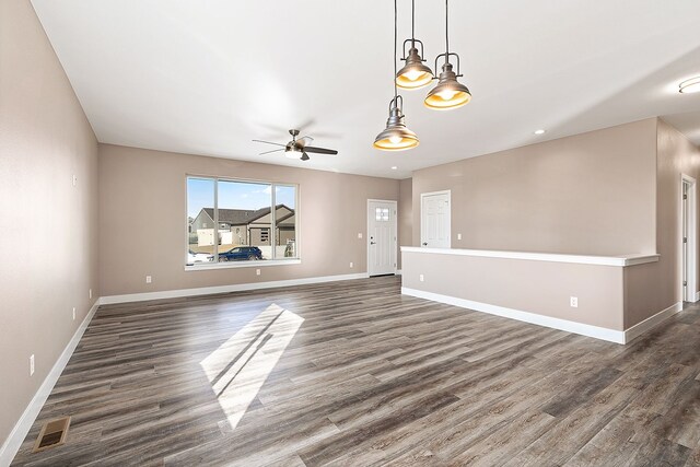 243 Stirling Loop, East Helena, MT 59635 - unfurnished living room with dark wood-style floors and ceiling fan