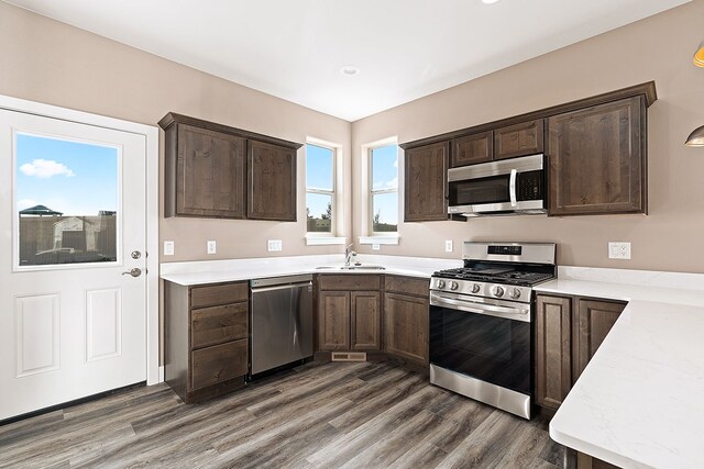 243 Stirling Loop, East Helena, MT 59635 - kitchen with stainless steel appliances, dark brown cabinets, wood finished floors, and recessed lighting