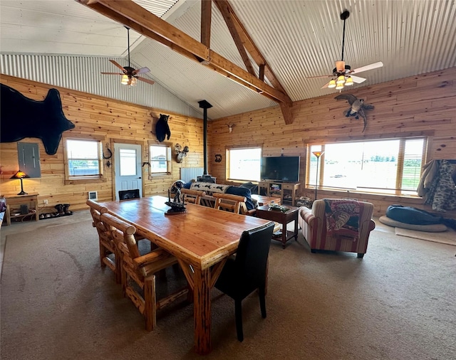 30 Kolbeck Ln, Hall, MT 59837 - dining space with a ceiling fan, a wood stove, wooden walls, carpet floors, and healthy amount of natural light