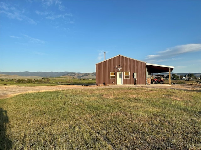 30 Kolbeck Ln, Hall, MT 59837 - view of home's exterior featuring a yard, a pole building, an outdoor structure, and a mountain view