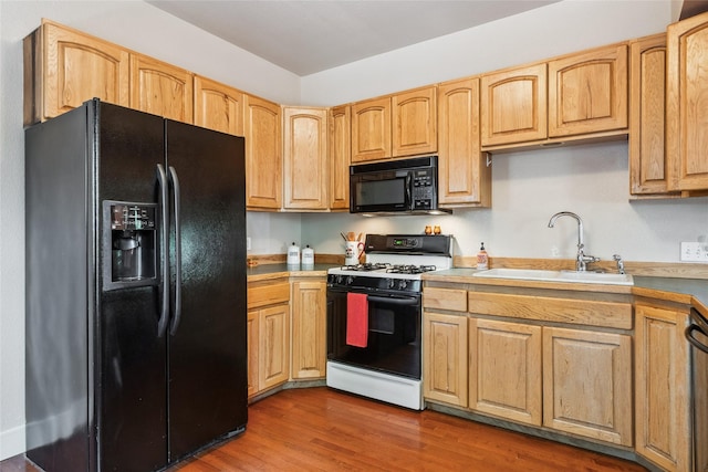 915 3rd St, Missoula, MT 59802 - kitchen featuring black appliances, wood finished floors, light countertops, and light brown cabinetry