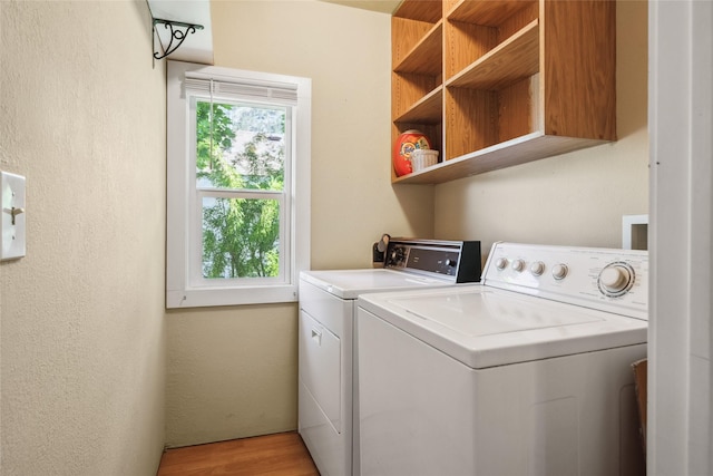 915 3rd St, Missoula, MT 59802 - washroom featuring washing machine and dryer, light wood-type flooring, and a textured wall