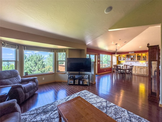3640 Jack Dr, Missoula, MT 59803 - living area featuring dark wood-style floors, lofted ceiling, and a textured ceiling