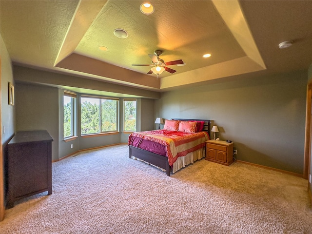 3640 Jack Dr, Missoula, MT 59803 - bedroom featuring a tray ceiling, light colored carpet, a textured ceiling, recessed lighting, and a ceiling fan